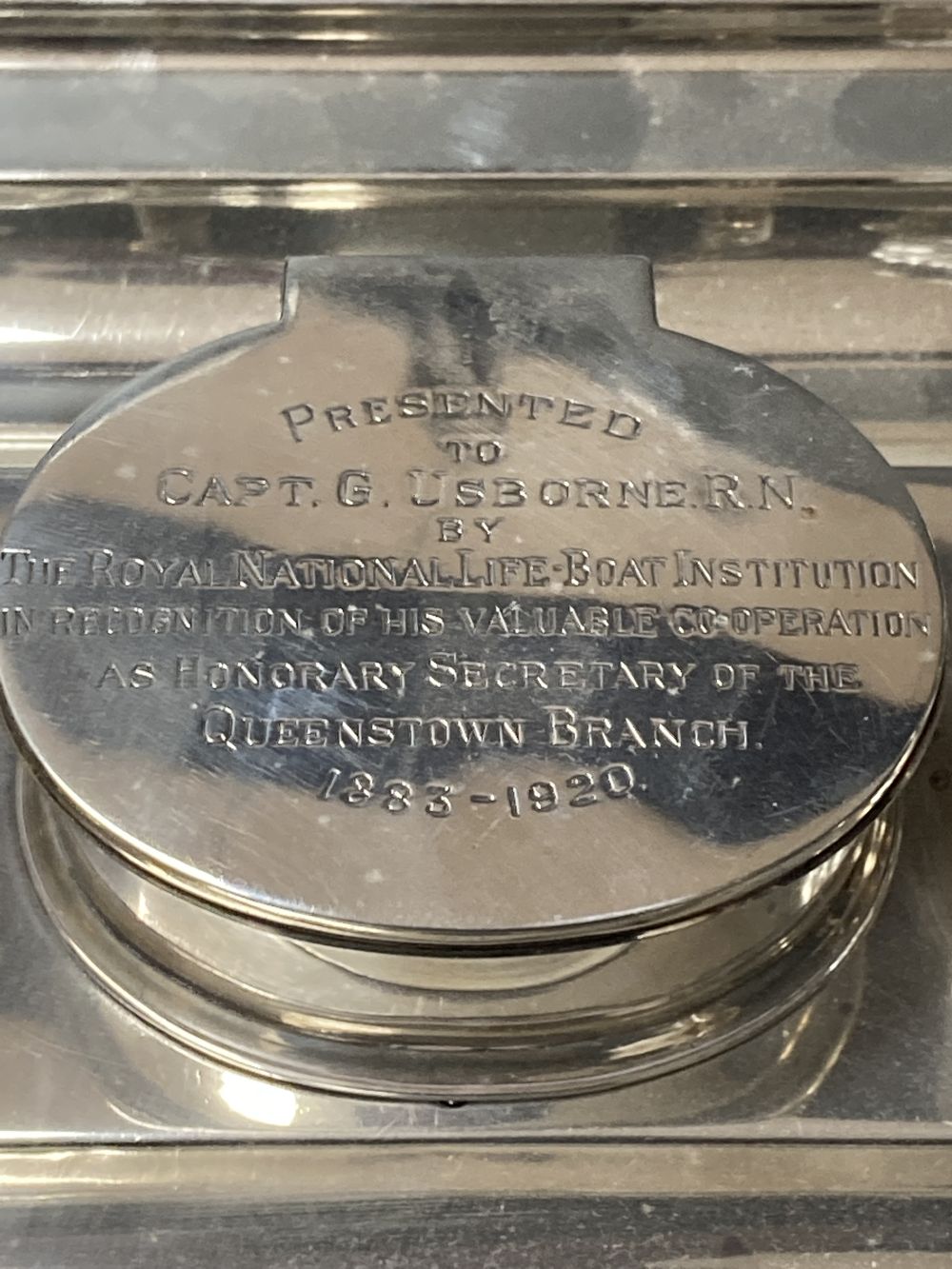 A late Victorian silver rectangular inkstand, with two mounted glass wells and central compartment